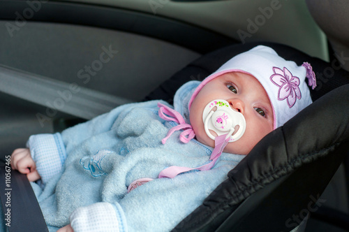 Child lying in the car autocradle photo