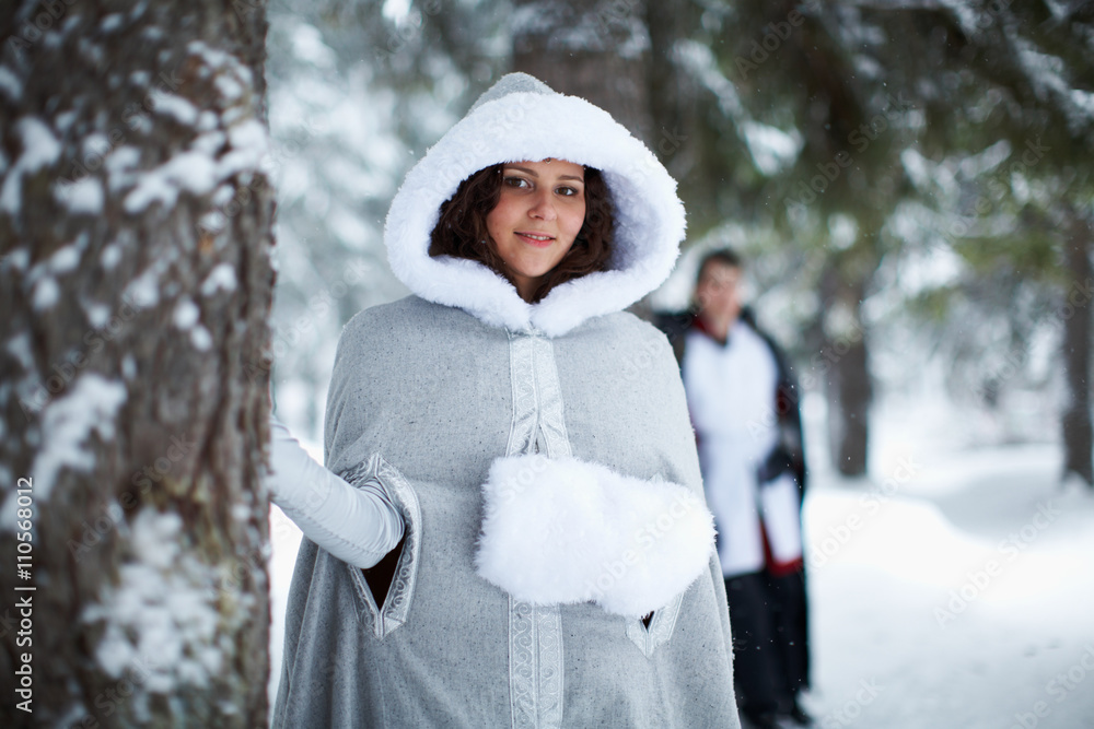 couple in medieval clothes in a snowy forest. Love concept for medieval design couple in medieval clothes in a snowy forest. Love concept for medieval design