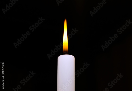 Candle flame closeup isolated on black background