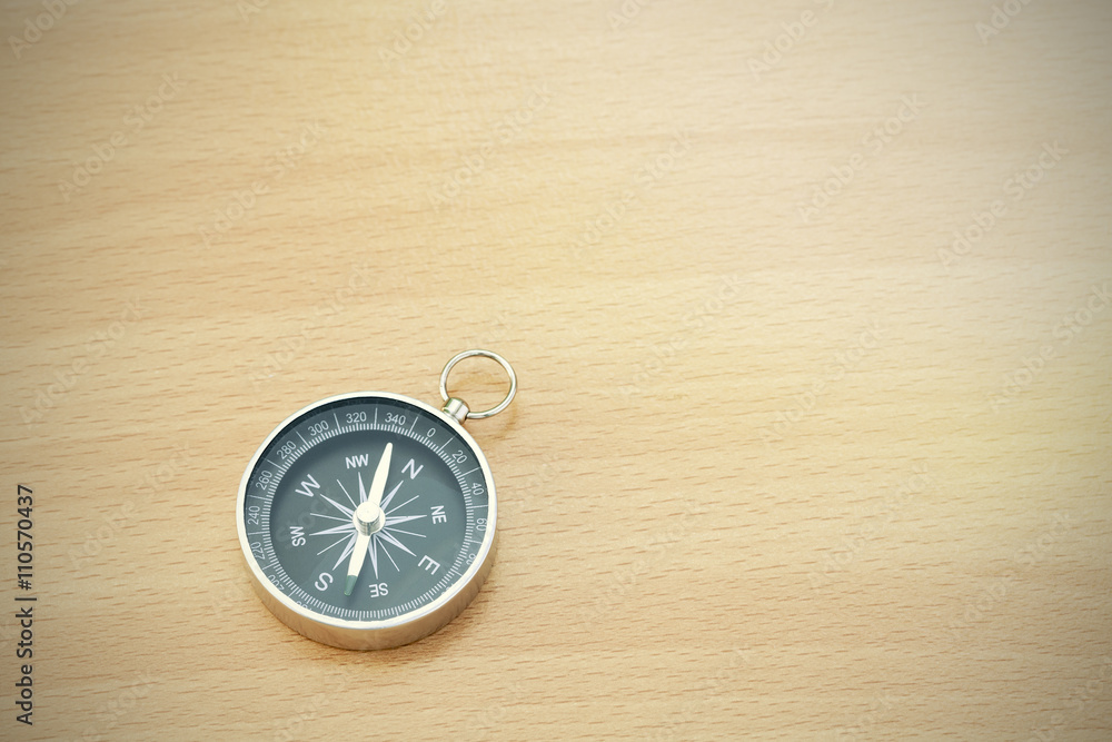 compass on old wood background with space for text. compass on old wood background with space for text.