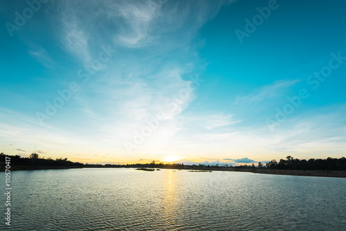 Sunset landscape over the lake with blue sky