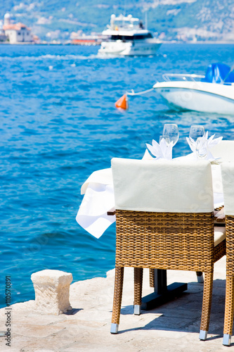 Table in the restaurant on the sea background, Perast