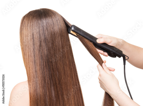 Makeup artist aligns long hair Curling on white