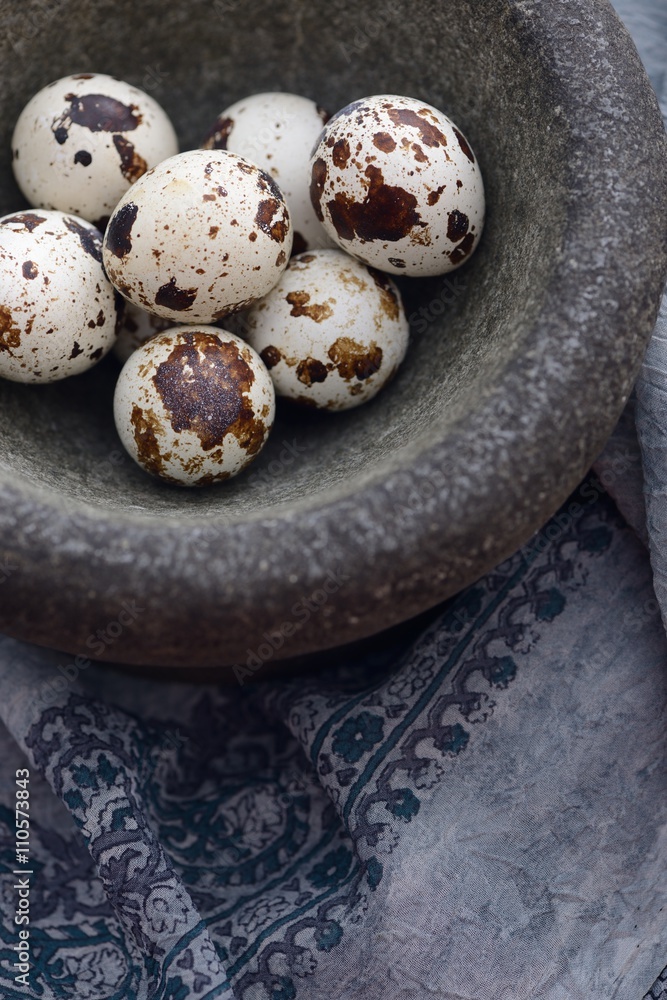 Obraz premium quail eggs in stone mortar