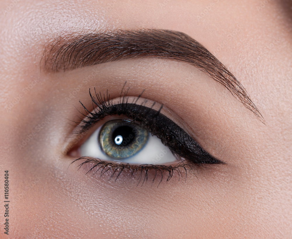 Female eye close-up. Macro. Perfect makeup and eyebrows. Beautiful gray eyes Female eye close-up. Macro. Perfect makeup and eyebrows. Beautiful gray eyes