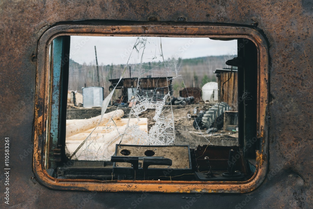 The view through the cab bulldozer with a broken windshield