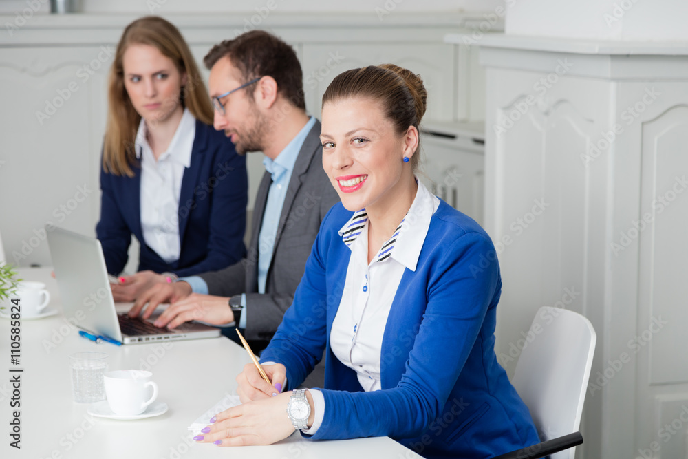 Φωτογραφία Portrait of a young businesswoman taking notes during the meeting