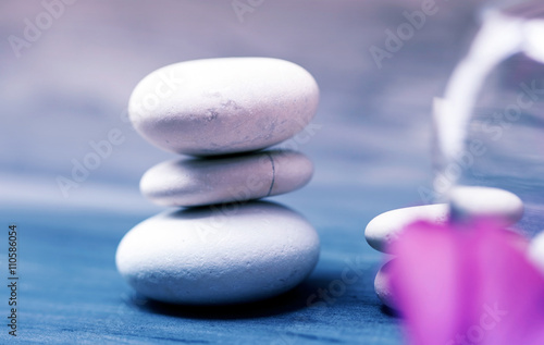 Photography Spa still life with pink orchid and white zen stones on dark background - retro