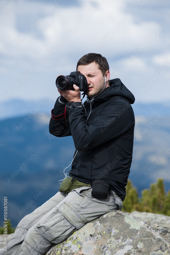 Nature photographer with digital camera on top of the mountain. Nature photographer with digital camera on top of the mountain.