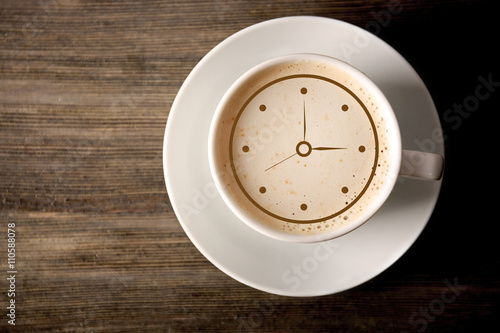 Konstfotografi Cup of coffee with clock drawing on foam, top view