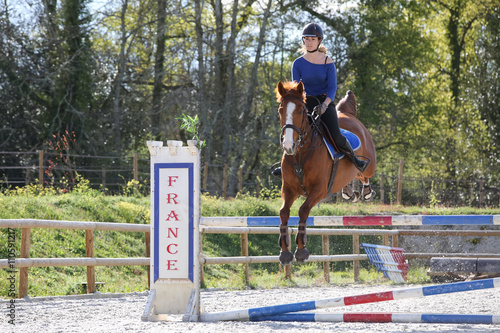 horsewoman training to jump before competition
