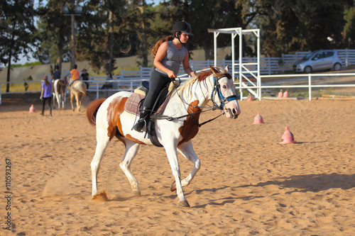 Teen girl is riding a horse