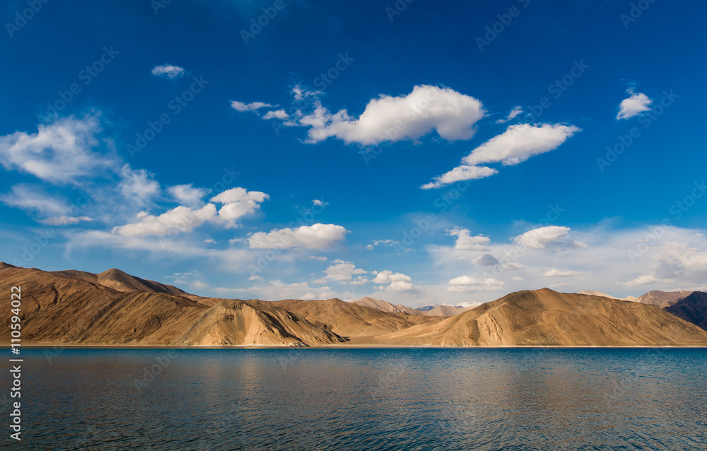 india, It is 134 km long and extends from India to Tibet. Leh, Jammu and Kashmir, ladakh, Pangong tso (Lake) with blue sky in background. It is huge lake in Ladakh, scenic