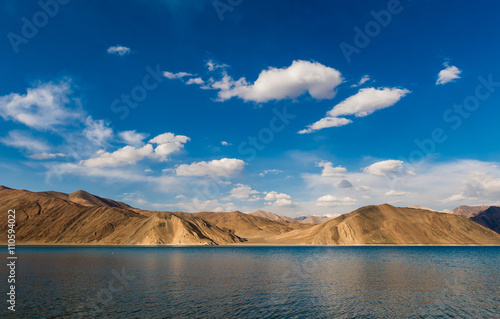 india, It is 134 km long and extends from India to Tibet. Leh, Jammu and Kashmir, ladakh, Pangong tso (Lake) with blue sky in background. It is huge lake in Ladakh, scenic