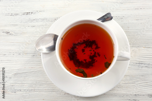 Cup of tea on white table, top view