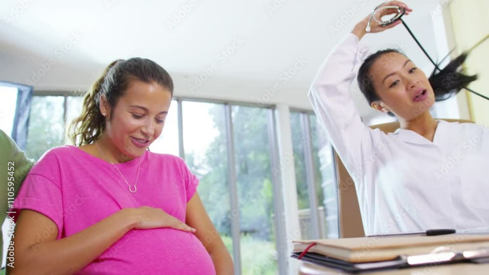 Friendly doctor talking to couple who are expecting a baby Friendly doctor talking to couple who are expecting a baby