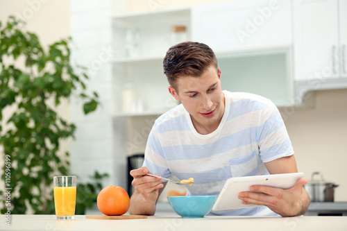 Handsome man with tablet an...