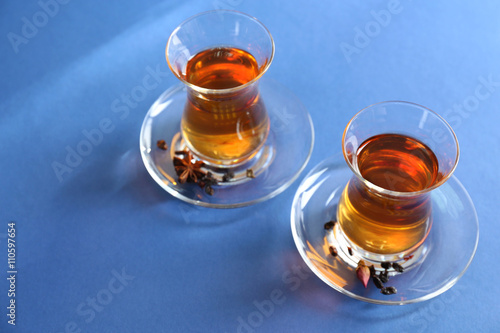 Glass cups of tea on blue background