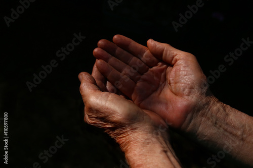 male Wrinkled old hands begging asking for money, help