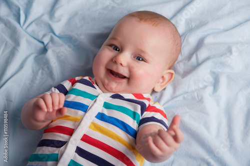 lying little baby is smiling