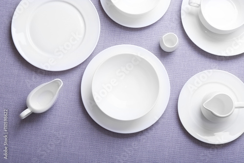 Empty white dishes on grey background.