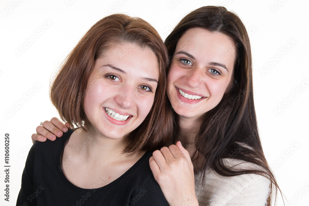 Young and beautiful sisters in friendship isolated Young and beautiful sisters in friendship isolated