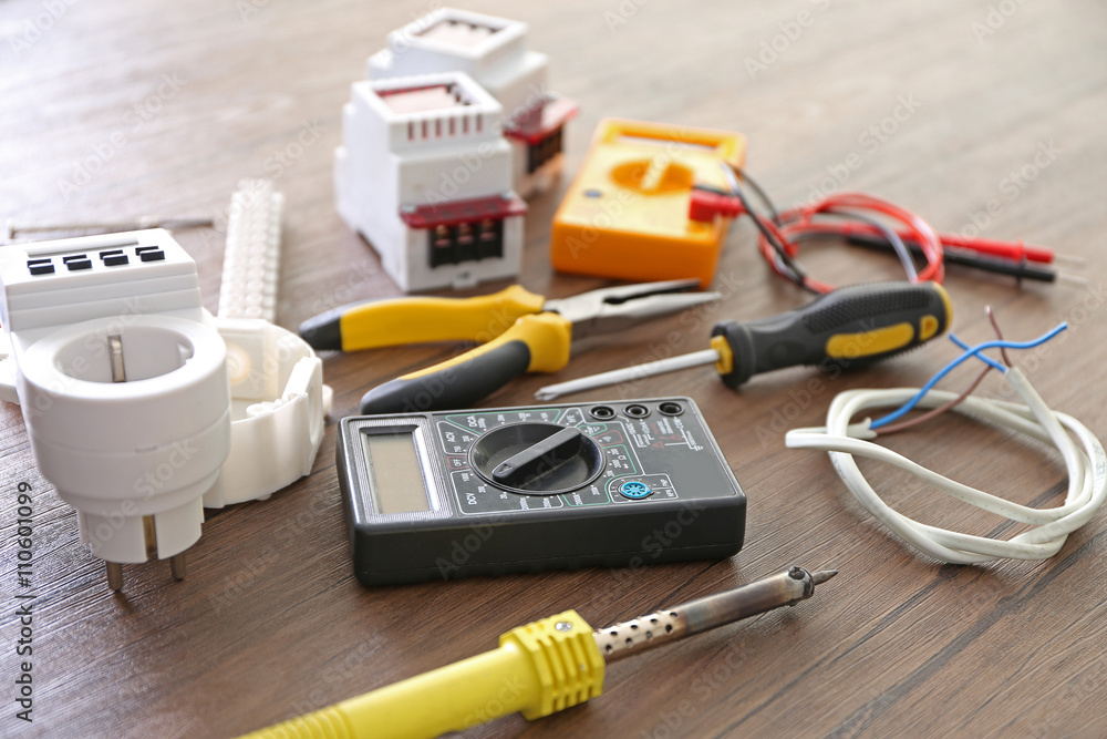 Different electrical tools on wooden table, top view Different electrical tools on wooden table, top view