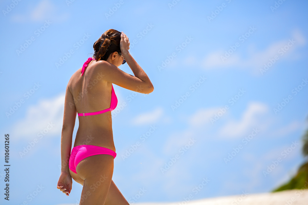 Maldives, a woman in a bikini walking along the beach
Maldives, a woman in a bikini walking along the beach