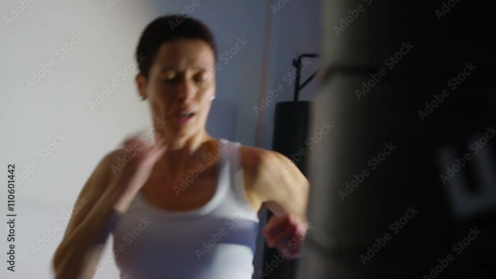 Serious female martial artist in training at the gym Serious female martial artist in training at the gym