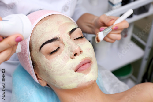 Young woman having face procedures in a beauty salon