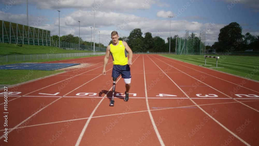 Portrait of disabled athlete with prosthetic leg crossing finish line Portrait of disabled athlete with prosthetic leg crossing finish line