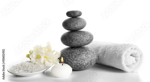 Spa still life with pebbles and candlelight isolated on white