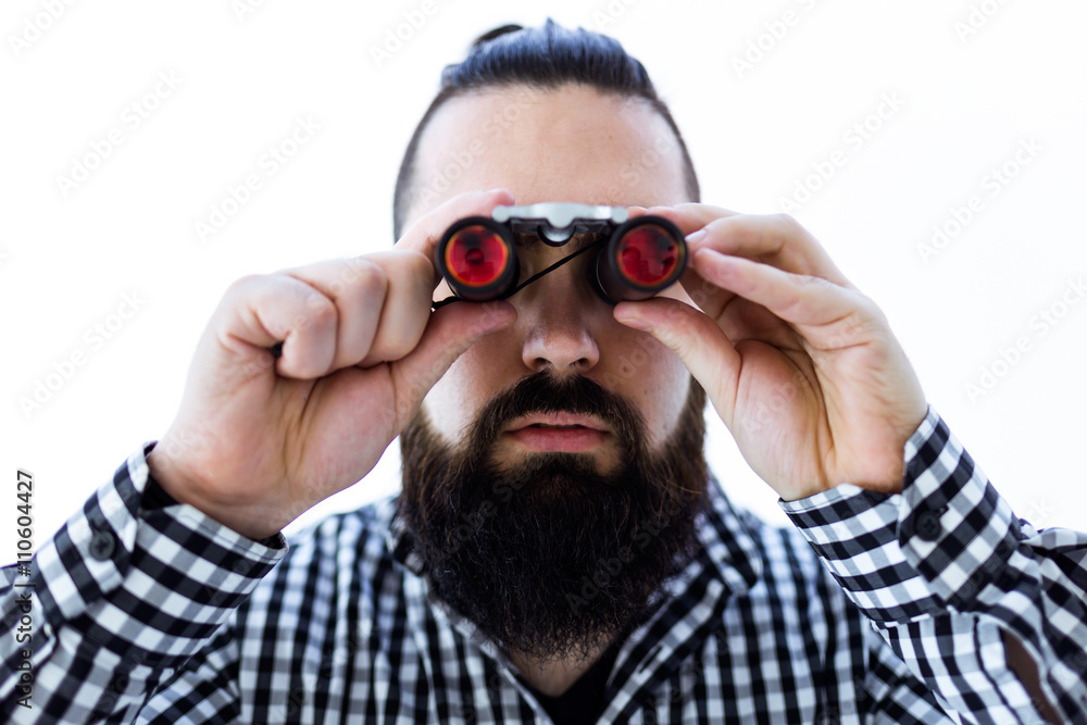 Young man with binoculars. Isolated on white. Young man with binoculars. Isolated on white.