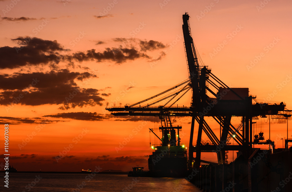Silhouette of container cargo and crane bridge