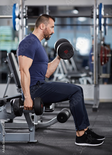 Man doing biceps curl seated
