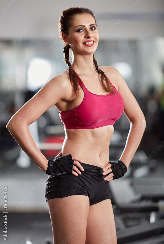 Fitness model posing in gym