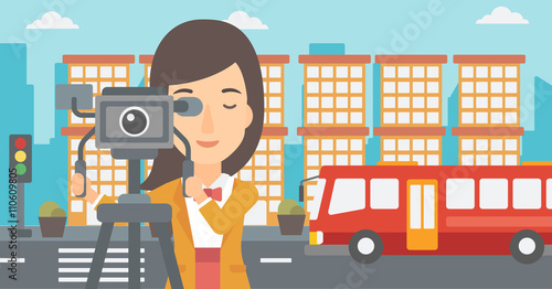 Camerawoman with movie camera on a tripod.