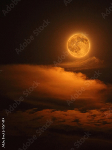 Moon colored Red On a Night Sky with Clouds