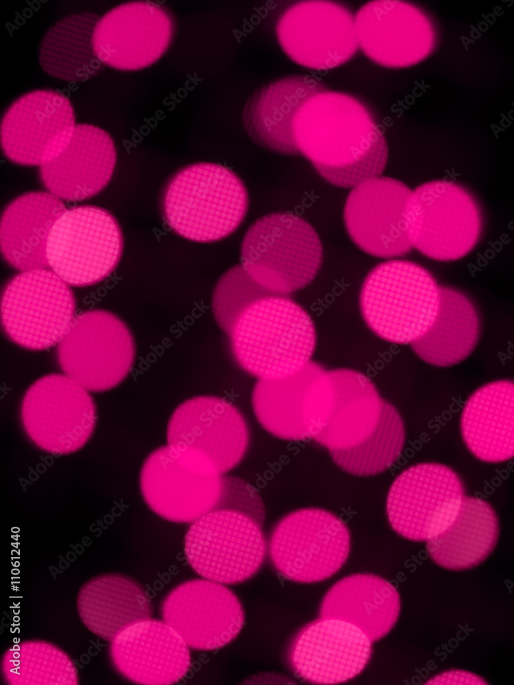 defocused image of pink halloween lights.