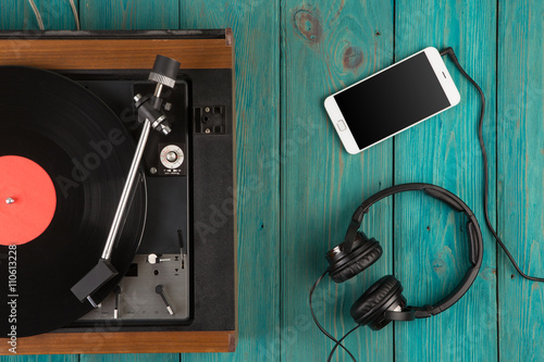 Vintage turntable, smartphone and headphones photo