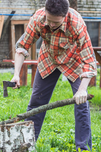Young man chopping wood