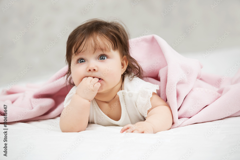 Portrait of baby girl lying on blanket at home Portrait of baby girl lying on blanket at home