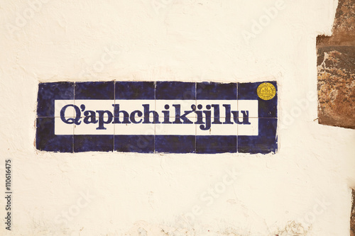 Street sign written in quechua in the old town of Cusco Peru