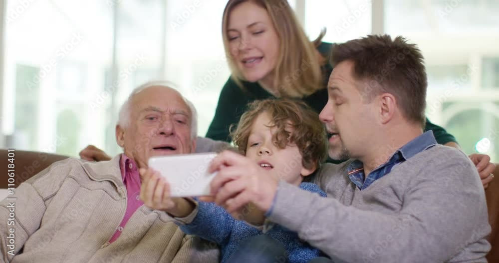 Family generations - 3 generations of family pose for selfie with camera phon Family generations - 3 generations of family pose for selfie with camera phon