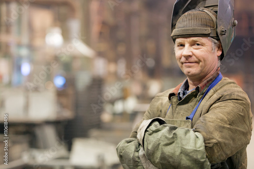 Portrait factory senior welder worker on manufacture workshop background photo