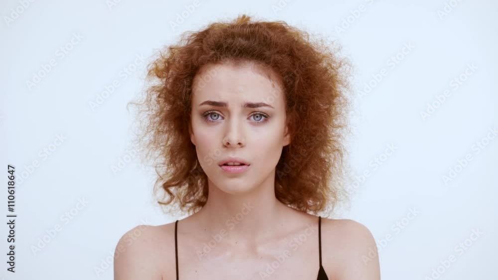 Scared girl on a white background. Close up. Slow motion Scared girl on a white background. Close up. Slow motion