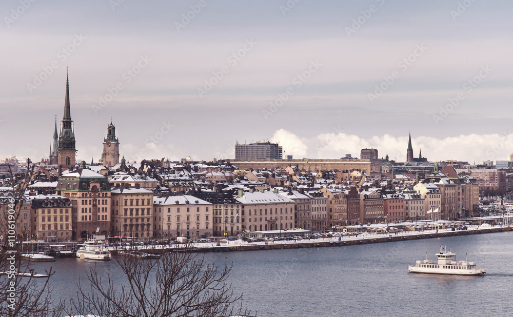 Vintage tinted snapshoot  Winter view over strait of Stockholm downtown. Boat onth water. Sweden