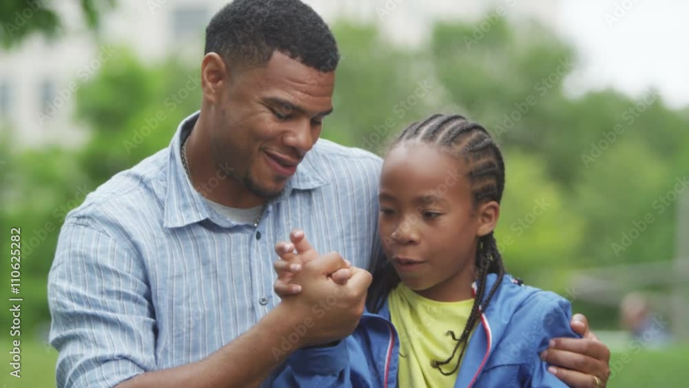 Portrait of happy African American father & son having fun in the park. Portrait of happy African American father & son having fun in the park.
