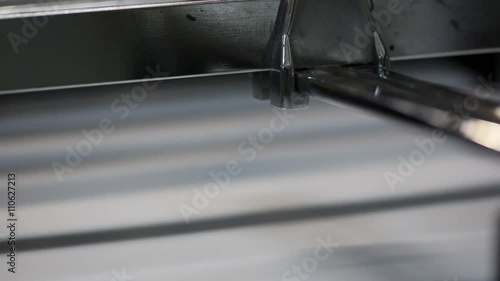 Details and mechanisms of the printing machine in motion.