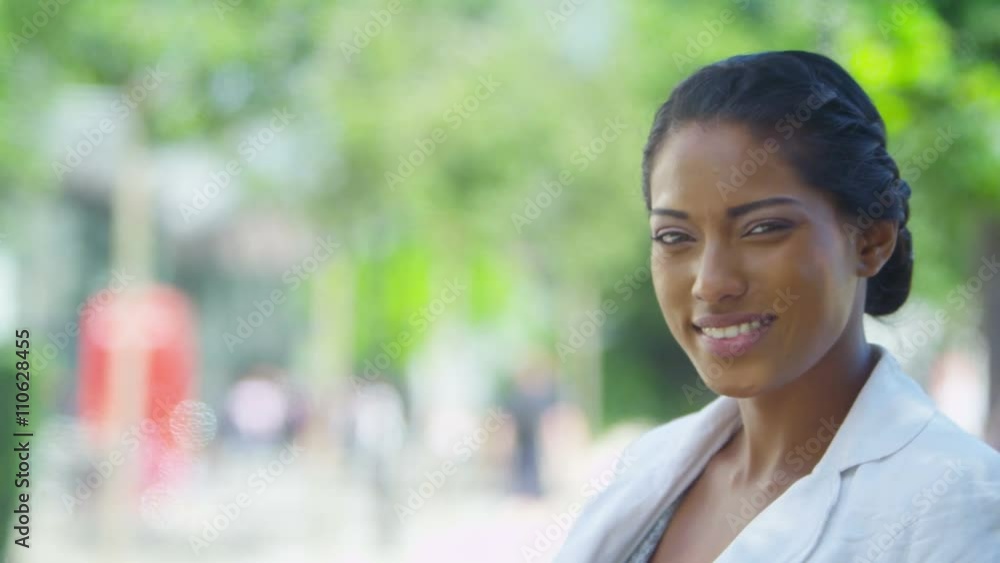 Portrait of beautiful woman smiling to camera outdoors in the city Portrait of beautiful woman smiling to camera outdoors in the city